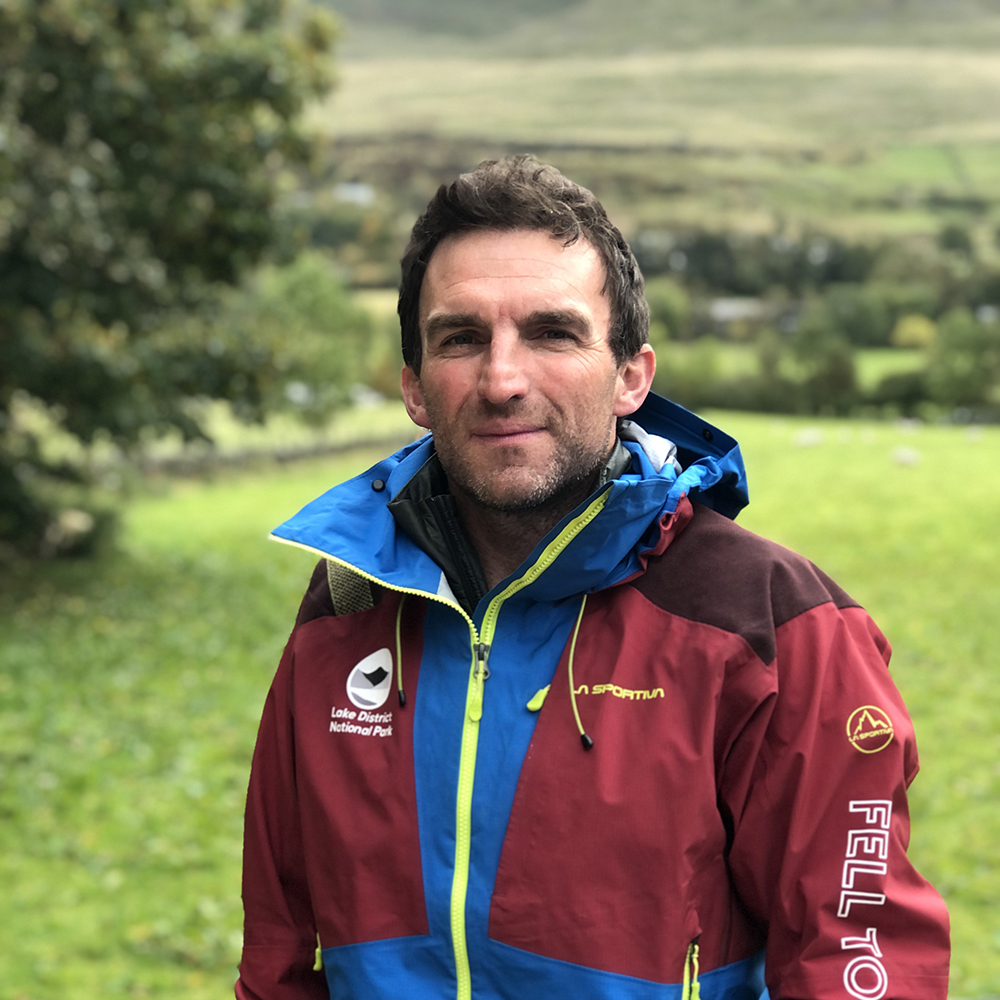 A man wearing outdoor kit on a hill